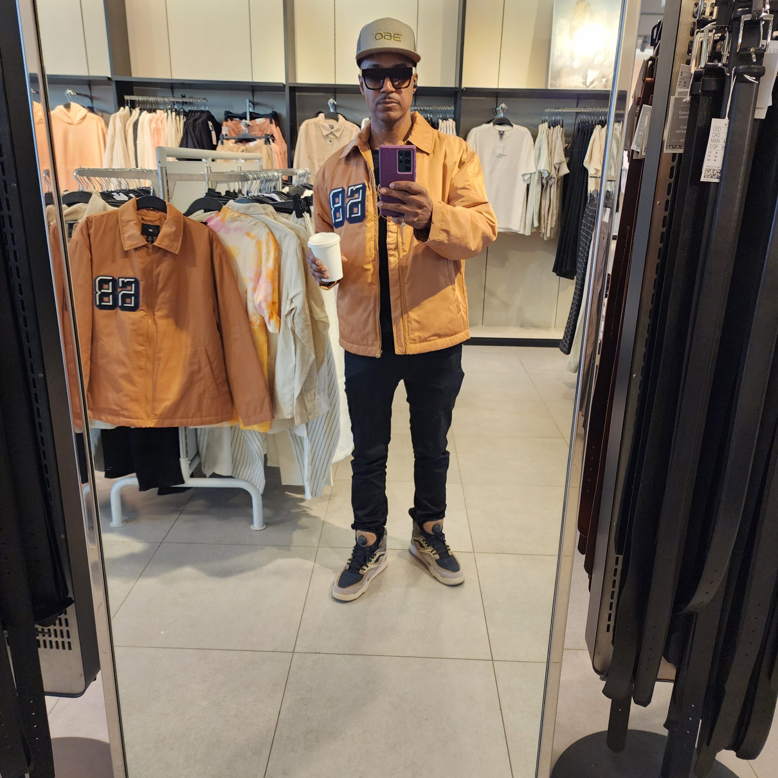 In order to withstand cooler afternoon temperatures, Vaughn shops for a bomber at H&M, wearing Tom Ford eyewear and Reebok Recreational Activities Sneaker. 